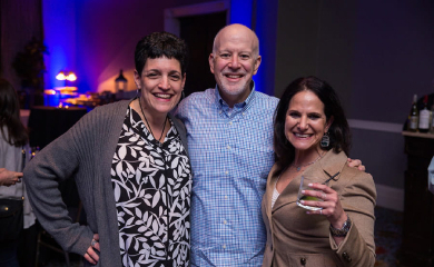 Group of three smiling parents at a community event