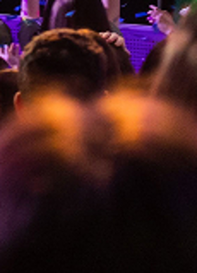 BBYO Centennial celebration with confetti, lights, and a crowd of attendees